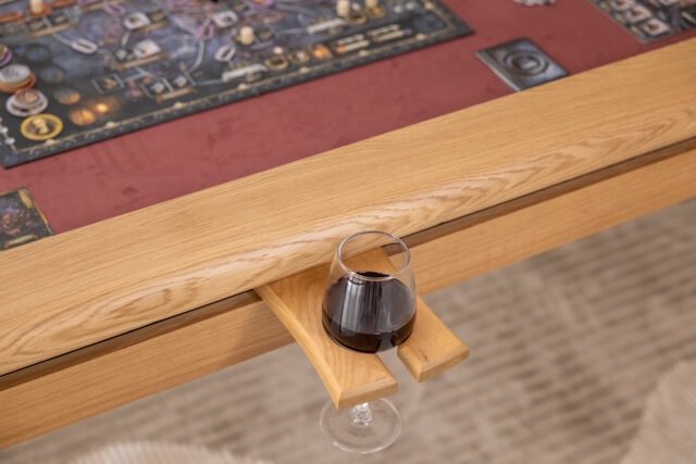 Wine glass held securely at the table edge